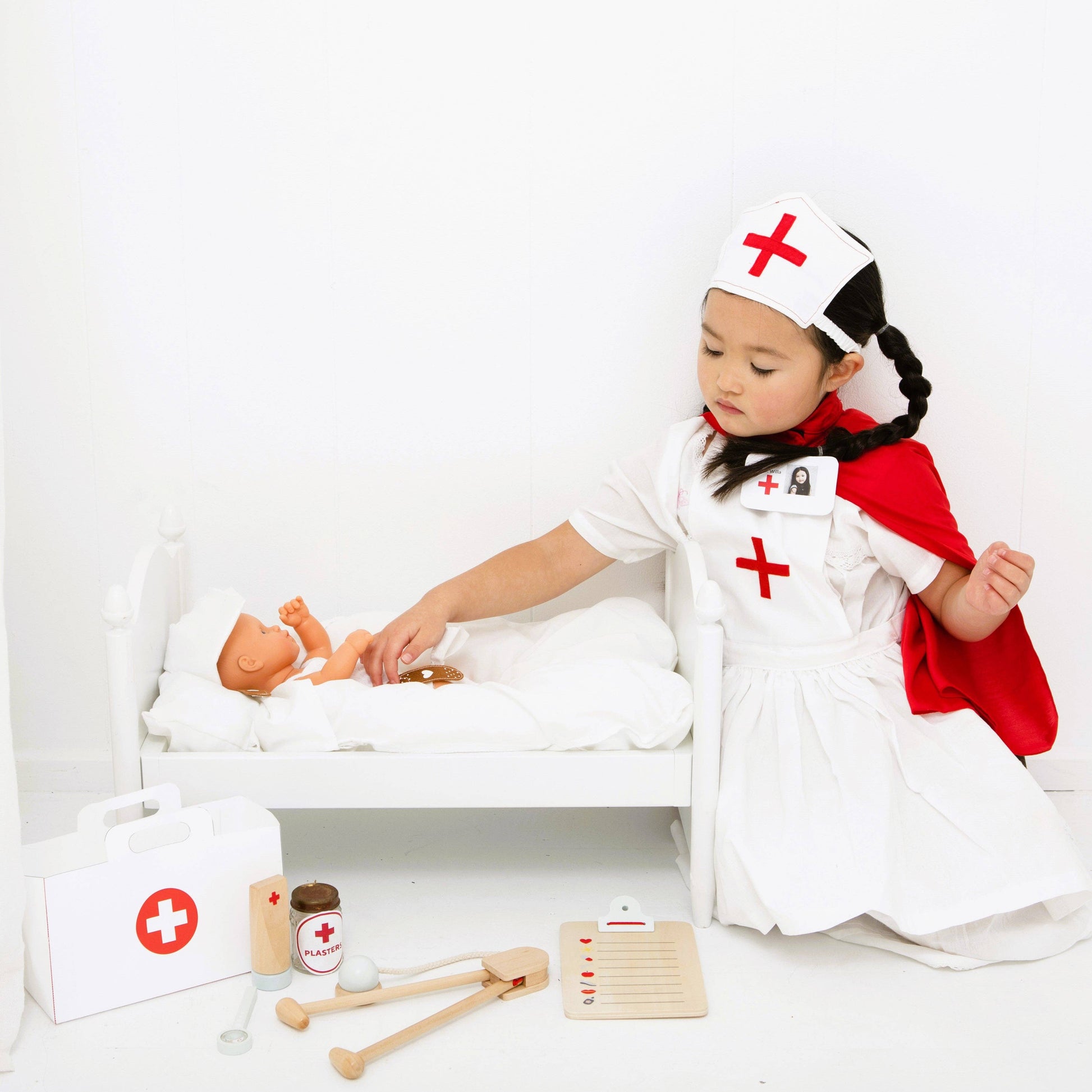 Make Me Iconic Wooden Pretend Play Doctors Kit - child playing with doll